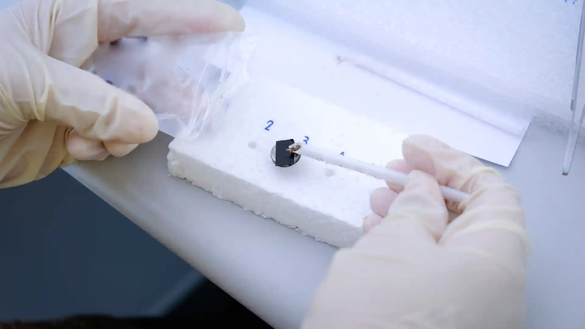 A scientist using a temperature probe during testing.