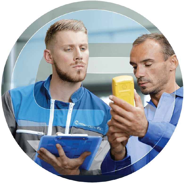 Two men on SensoScientific’s technician team checking calibration on a device